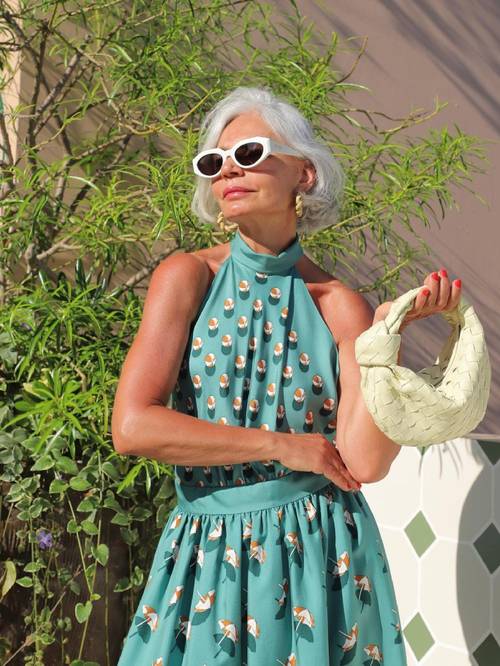 What to Wear to a Summer Wedding: @GRECEGHANEM wears a teal halter neck with a pair of white retro sunglasses
