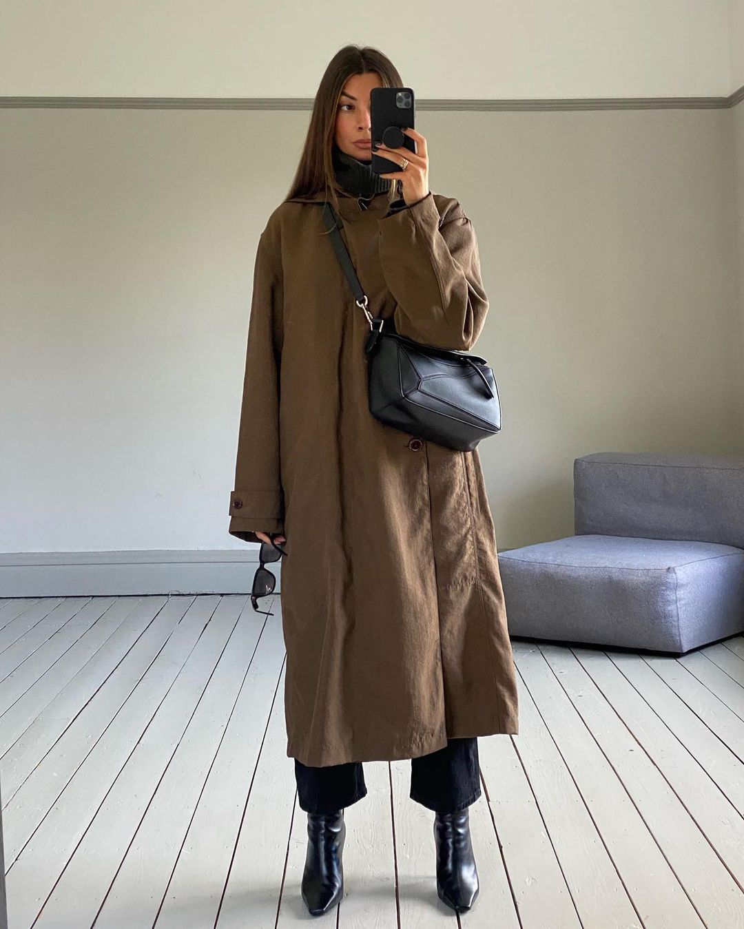 @smythsisters wears a nylon-canvas maxi coat with boots and a crossbody bag