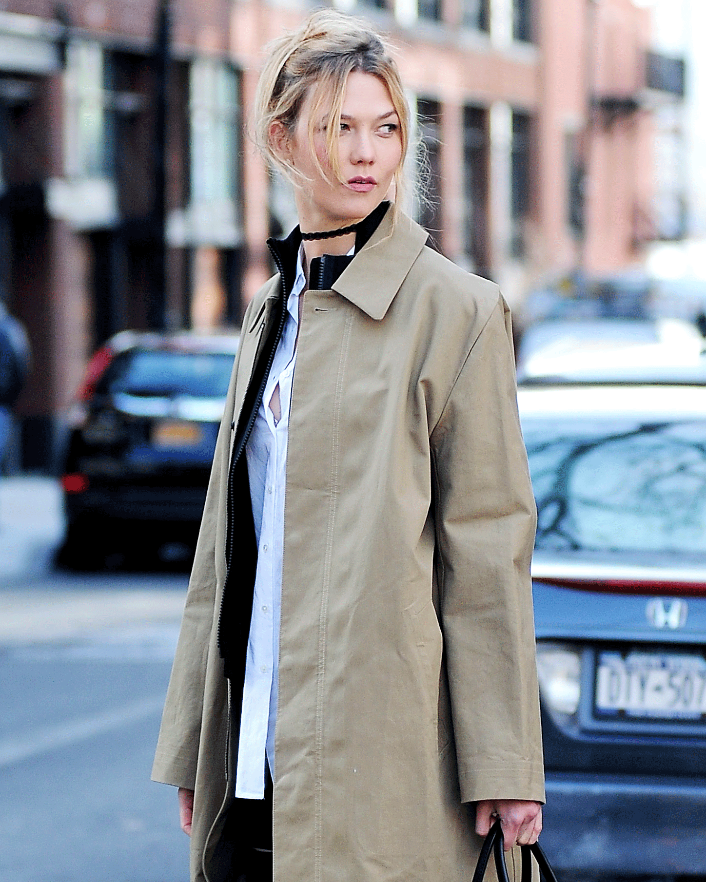 Karlie Kloss in a trench coat and white shirt