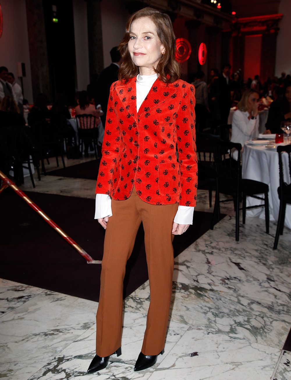 over 50 fashion and clothing inspiration: French actress Isabelle Huppert wearing a printed Chloé blazer with brown flares