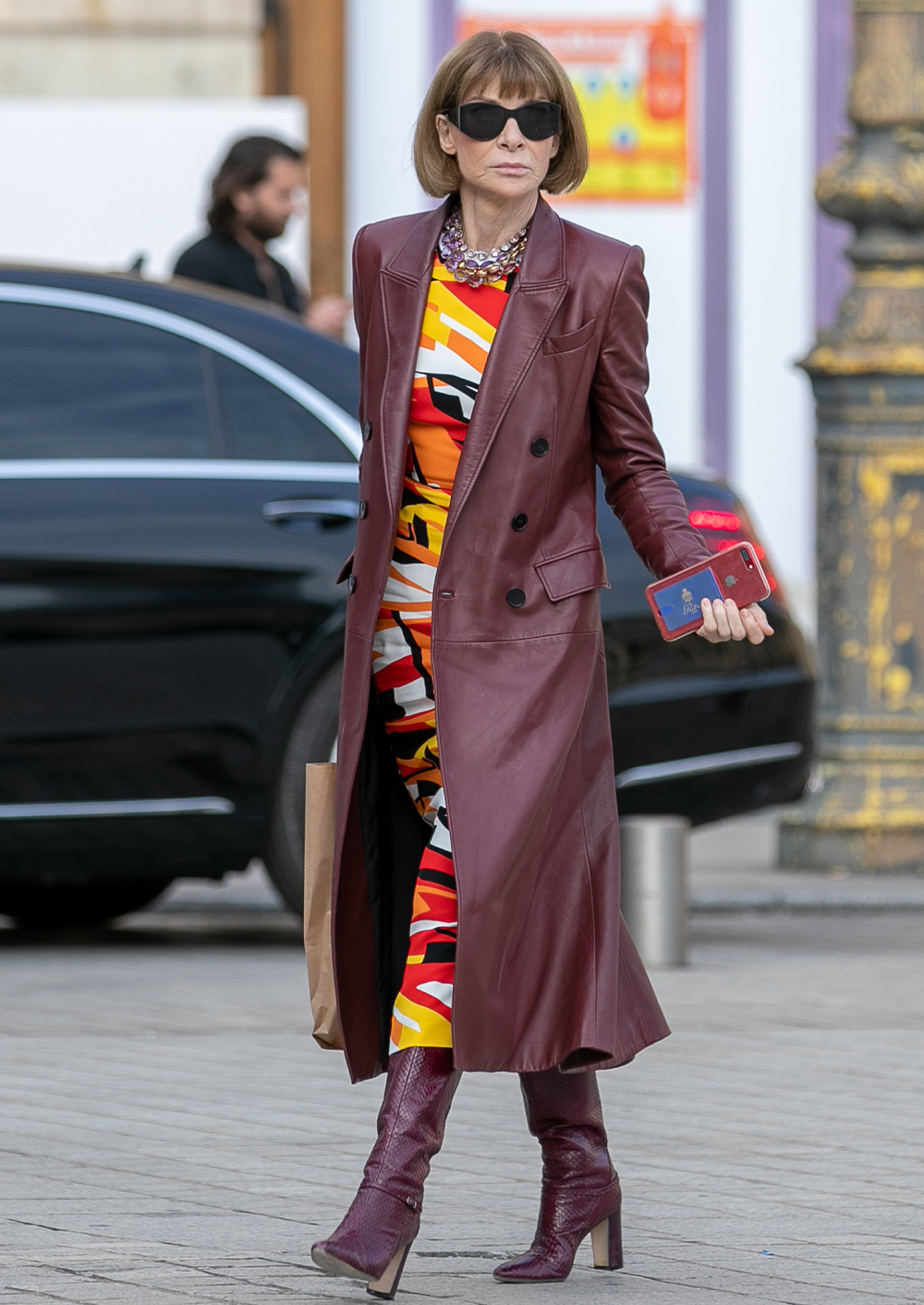 over 50 fashion and clothing inspiration: Anna Wintour in a leather coat, printed dress and knee boots