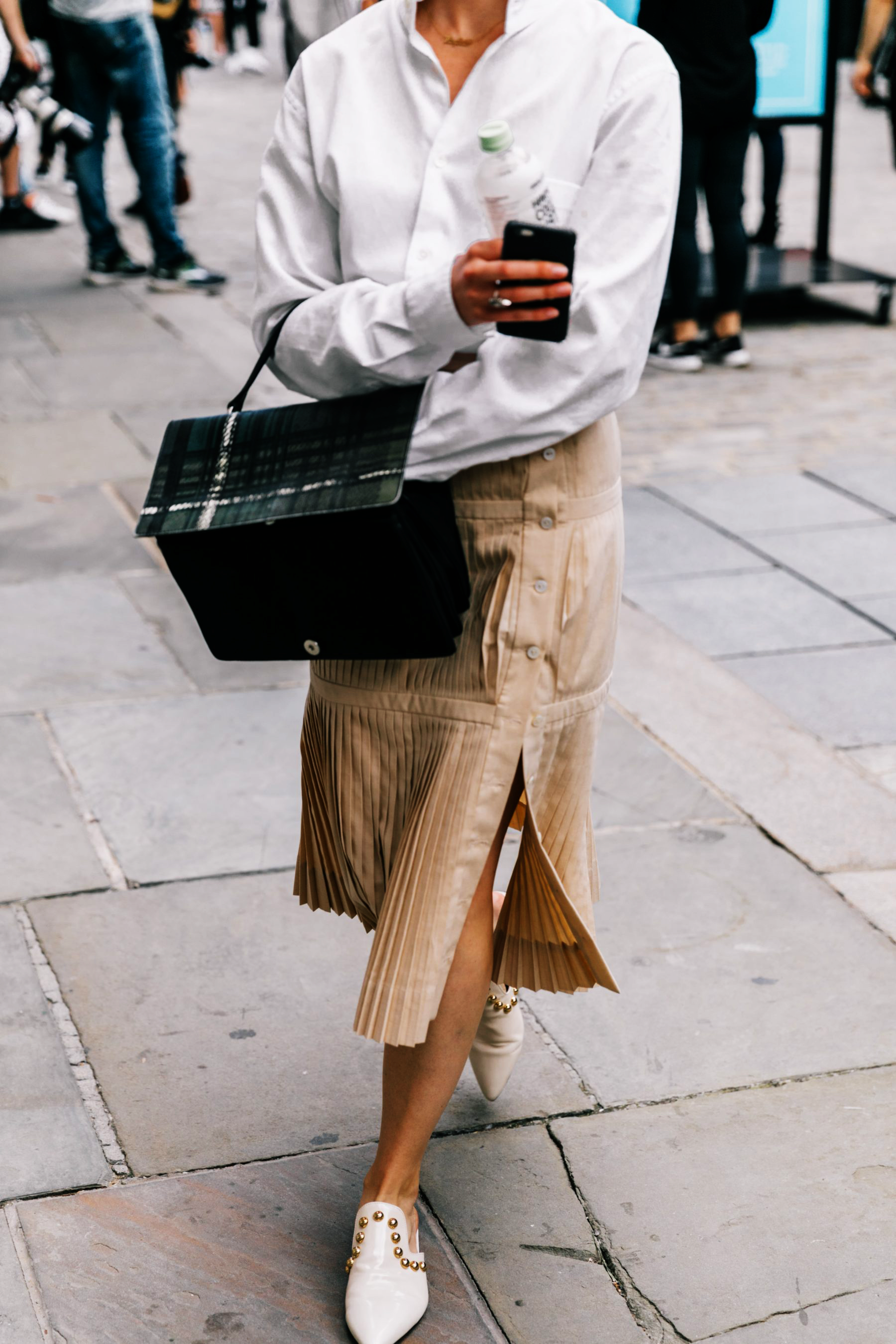 Street style white shirt and tan skirt with black bag