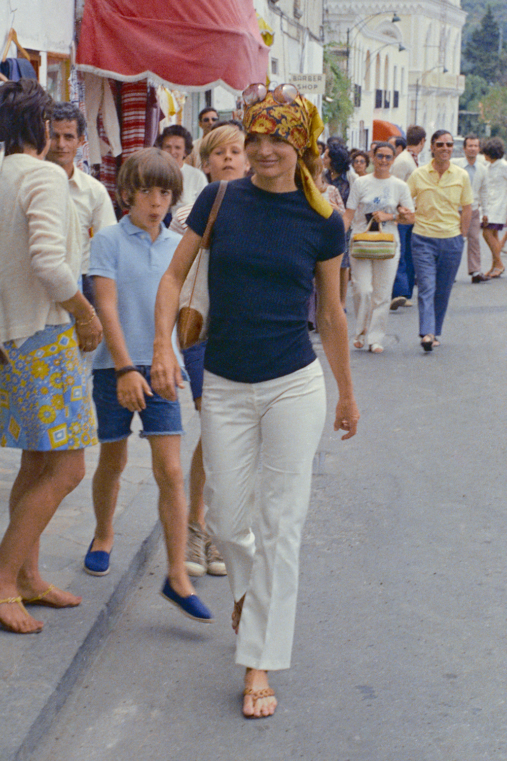 1970s fashion: Jackie Onassis wearing a headscarf on holiday in Capri