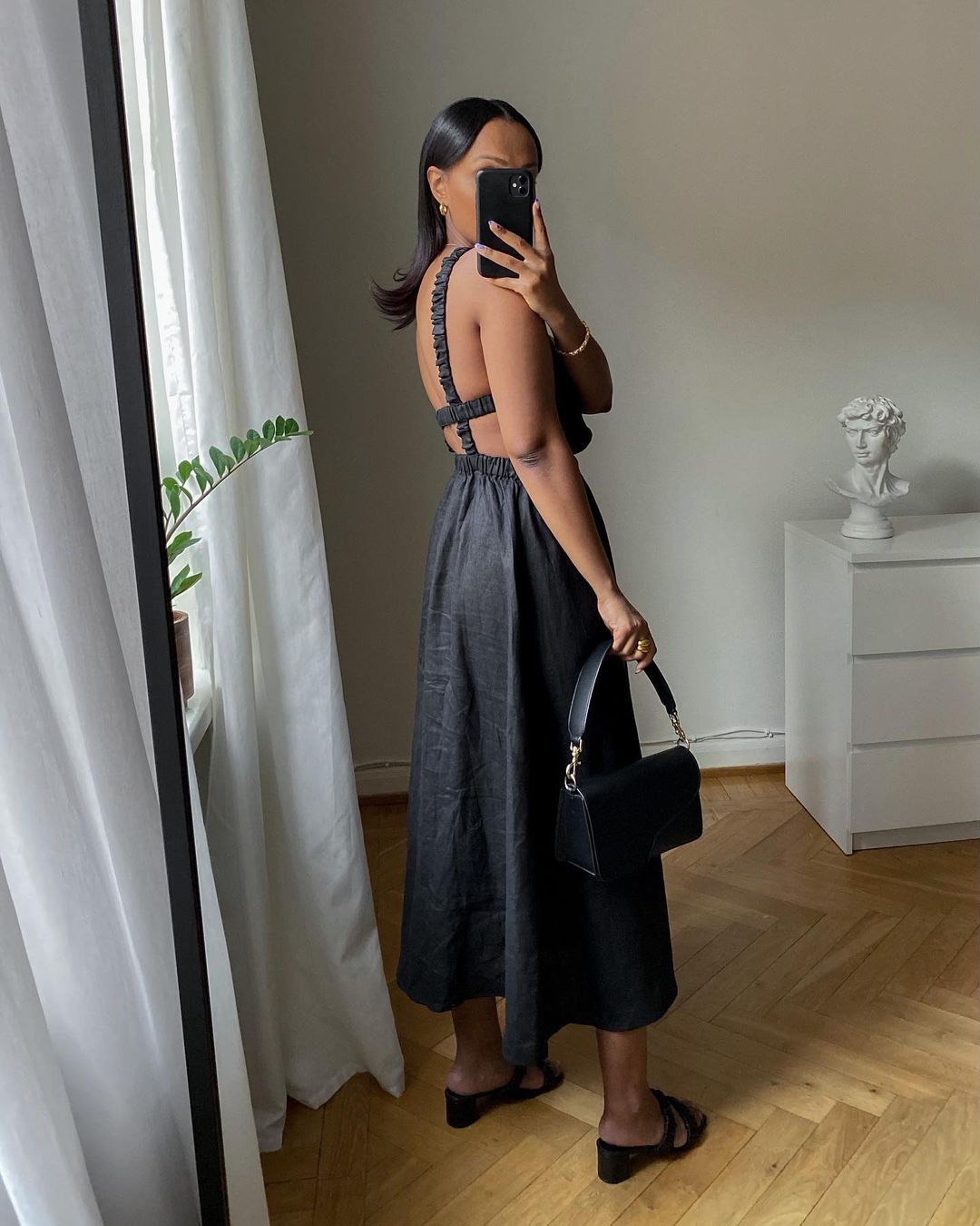 Best stick-on bras and adhesive cup bras: @femmeblk wears a black backless dress