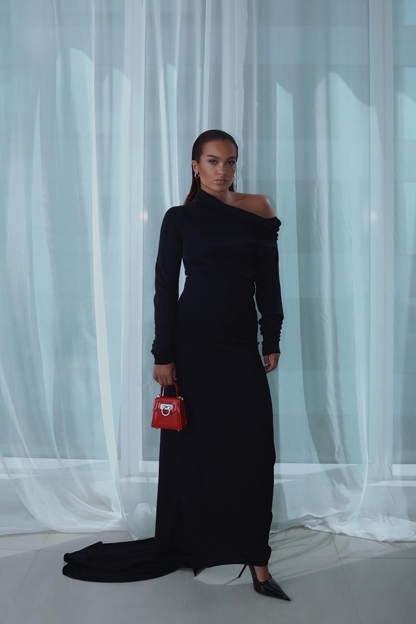 how to dress for a black-tie event, a photo of a woman wearing a black gown