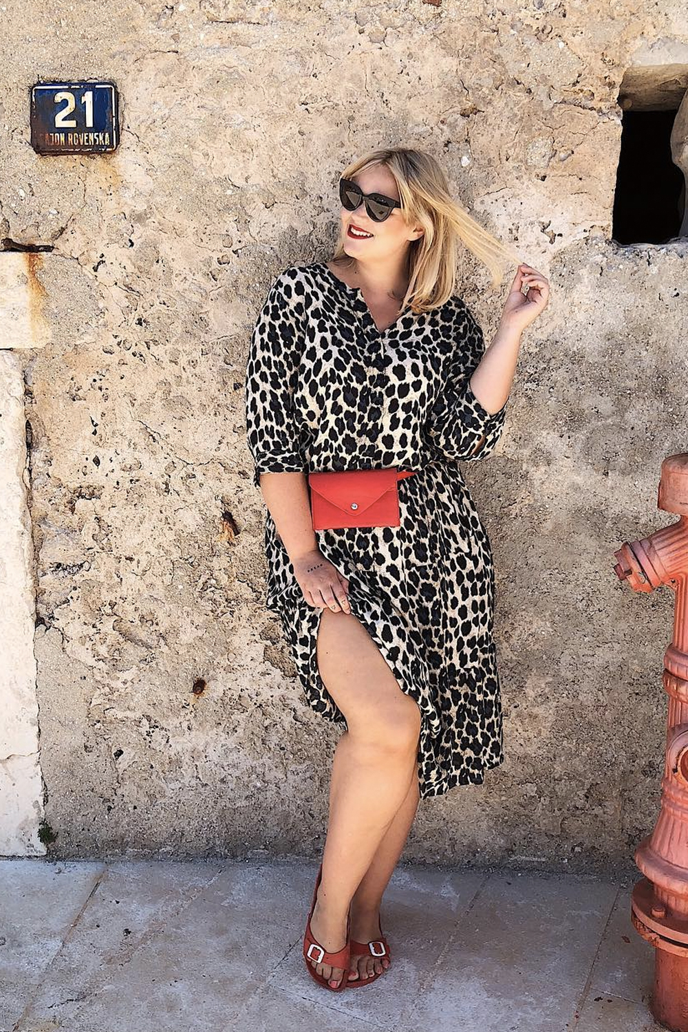 what to wear in September: Charlotte Kuhrt in a leopard-printed dress and red accessories