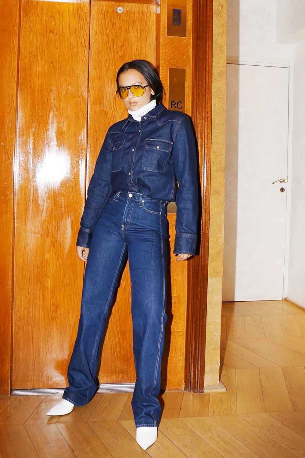 Roll neck under shirt fashion trend: Oumayma Elboumeshouli wearing denim Calvin Klein shirt and jeans