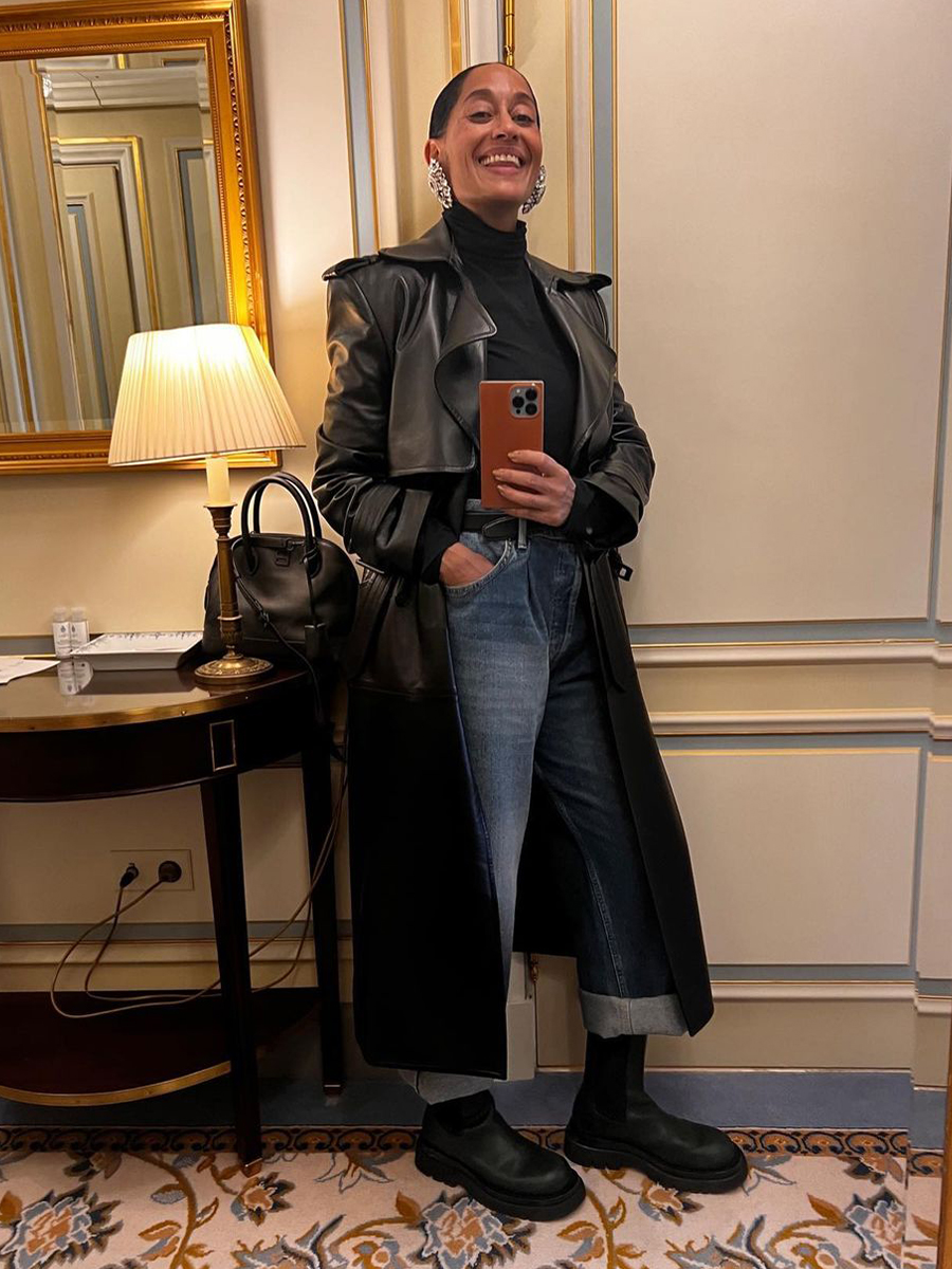 Tracee Ellis Ross wears a leather trend coat, black turtleneck, jeans and boots.