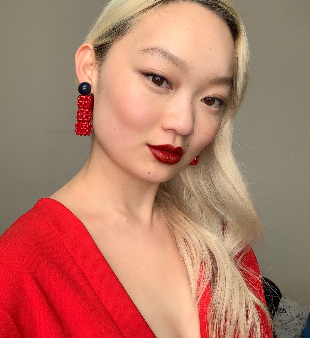 Matching Earrings and Makeup: Jessica wearing red lipstick and earrings
