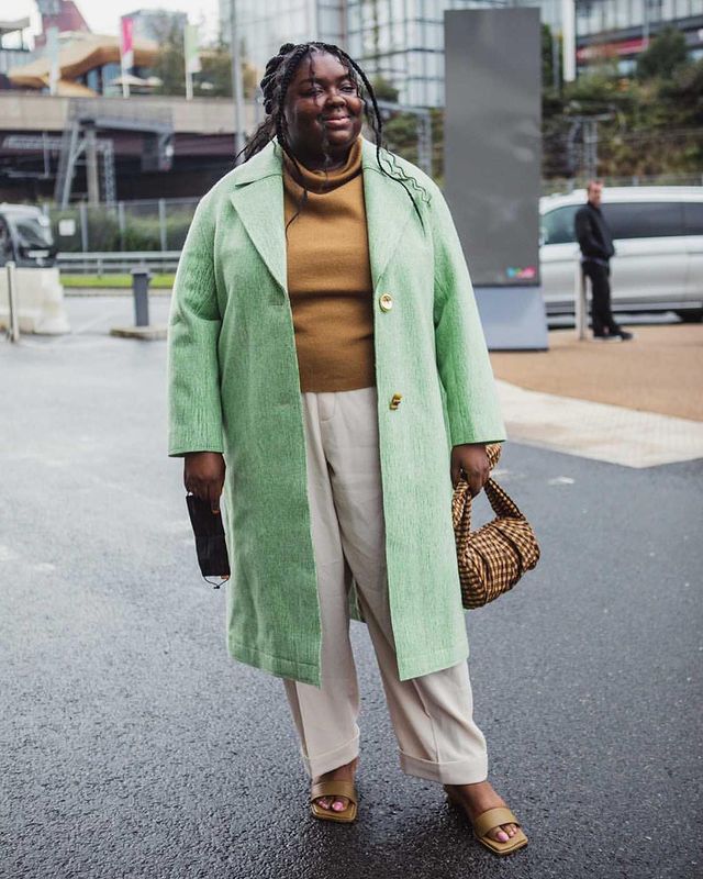 What to Wear in October: Abi Marvel wears a green coat with a tan roll neck and cream trousers