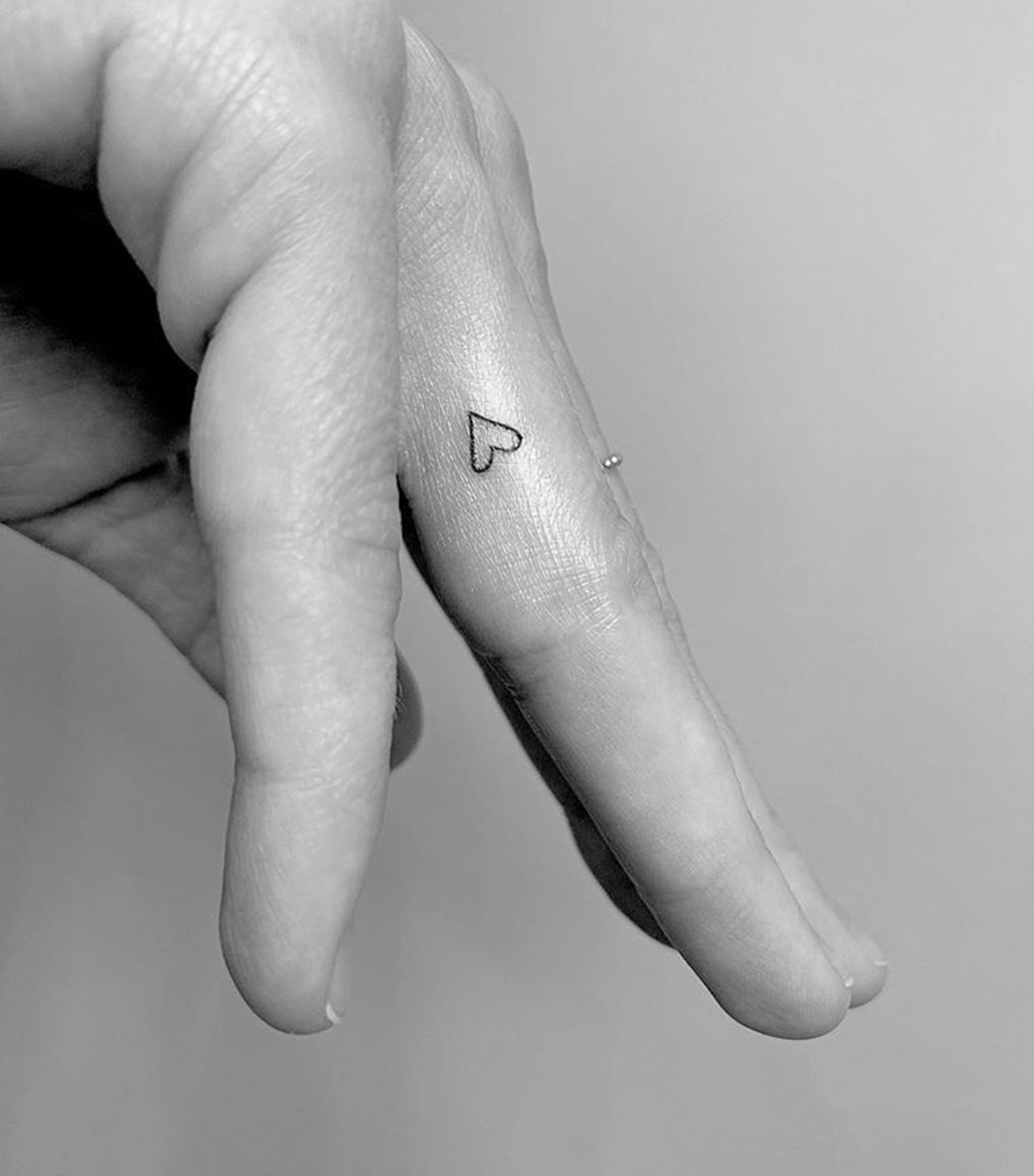 Heart finger tattoo