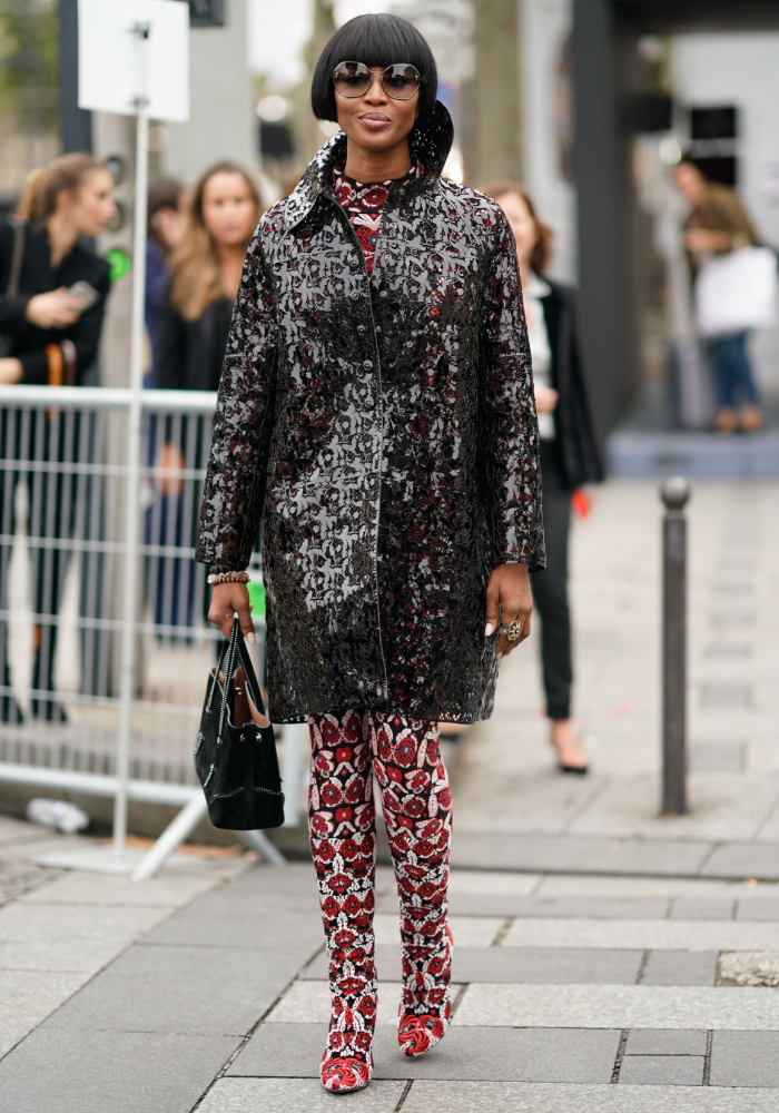 best street style outfits: naomi wearing a black jacket over a printed outfit