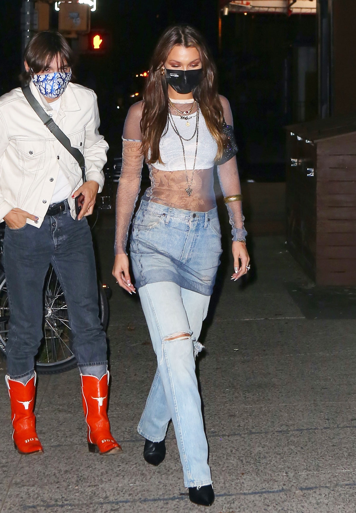 Bella Hadid wore a face mask with a sheer dress and jeans