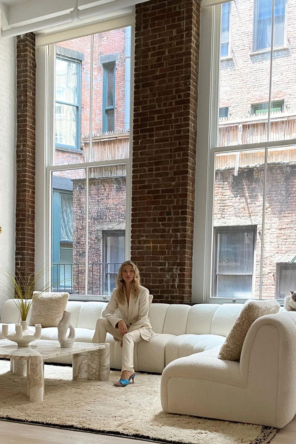 white boucle trend: Elsa Hosk with a white boucle sofa