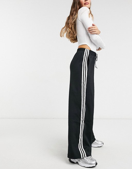 Adidas Originals three stripe flared track pants  Manifesto Woman