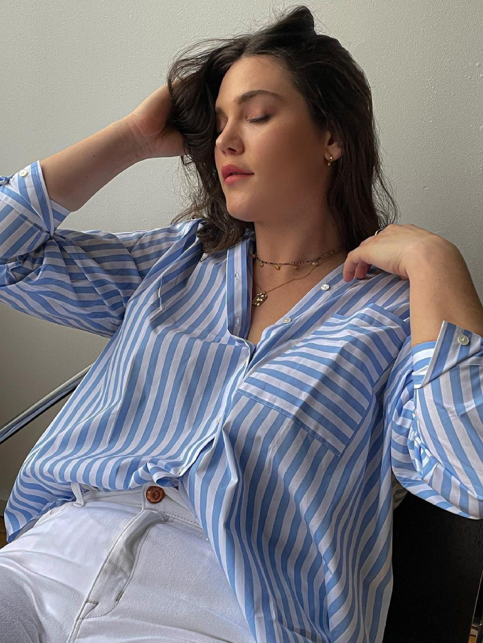 wishlisting spring items: ali tate cutler wearing a striped blue shirt and white jeans