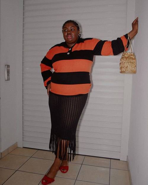 Spring Pattern Trends: Abi Marvel wears an orange and black stripe top