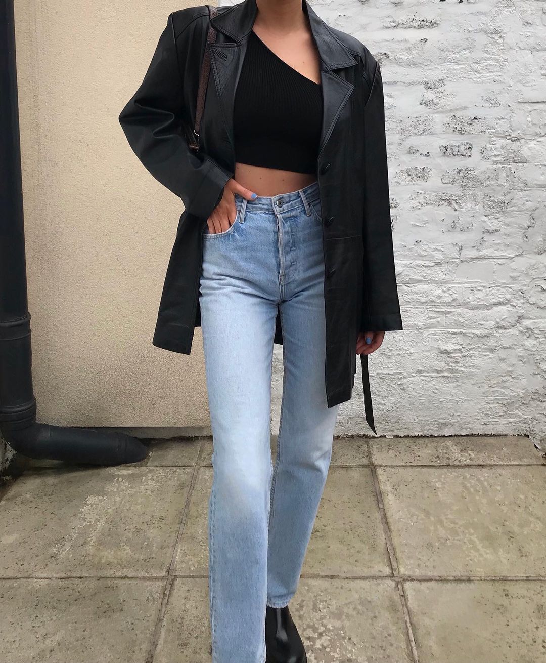 bra and blazer outfits: leather jacket with asymmetric crop top and jeans