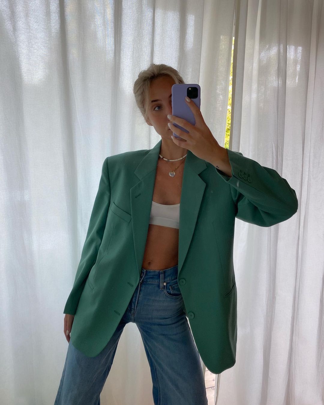 bra and blazer outfits: green blazer with jeans and a knit bralette