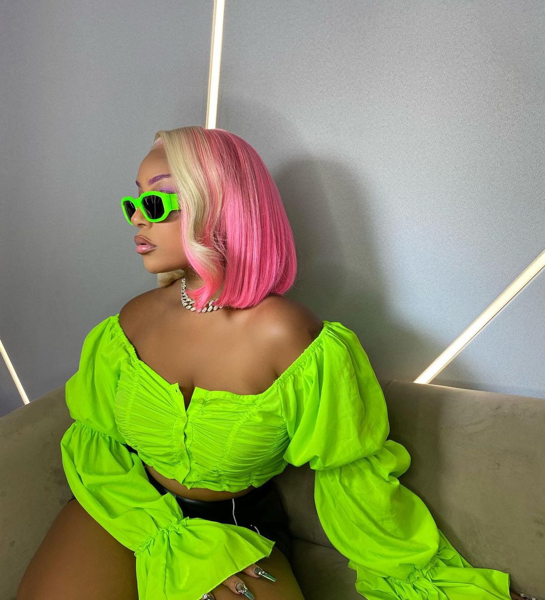 Stefflon Don wearing lime green crop top and sunglasses