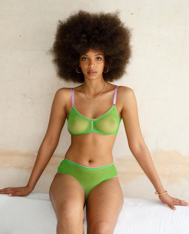Lingerie Trends 2022: A model wears a green bra and knicker set