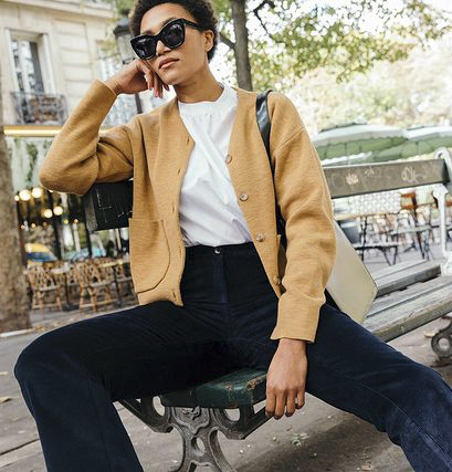 French Girl Corduroy Outfits: @lenafarl wears a pair of navy corduroy trousers with a tan cardigan