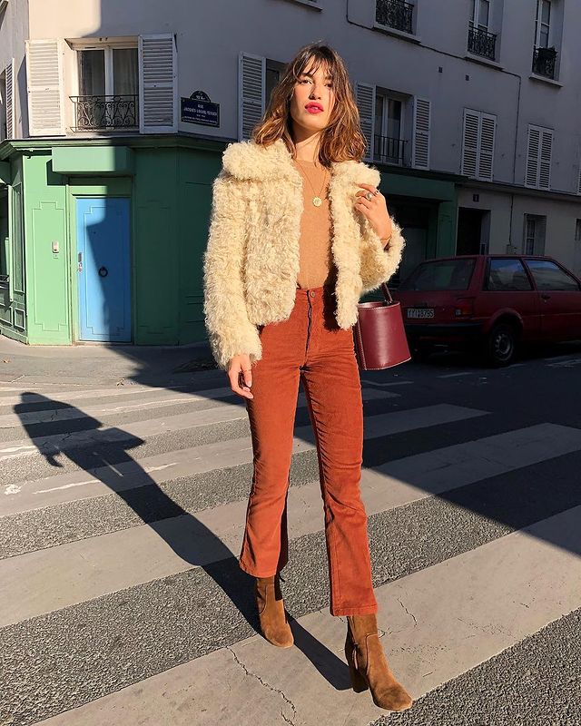 French Girl Corduroy Outfits: @jeannedamas wears a corduroy pair of trousers with a shearling jacket