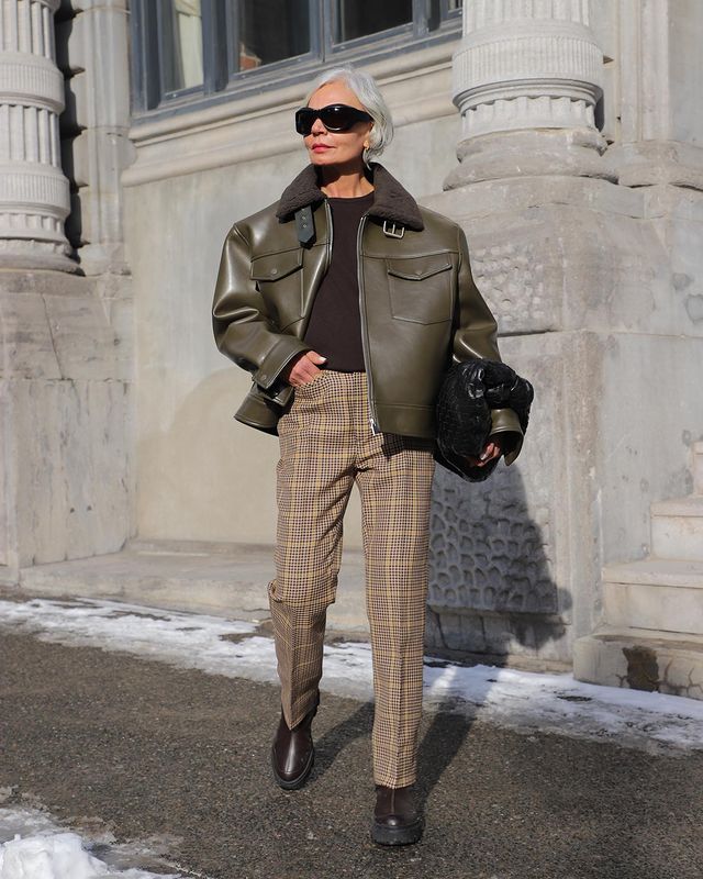 Easy Winter Outfits: @greceghanem wears an olive leather jacket with checked trousers and a brown knit
