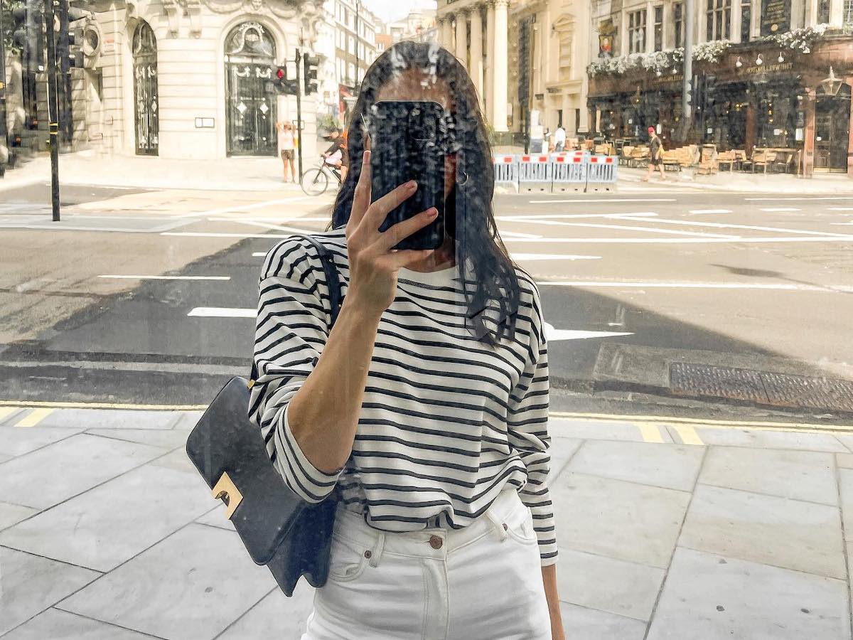 Influencer Jessica Skye in classic affordable fashion like a striped shirt and white jeans