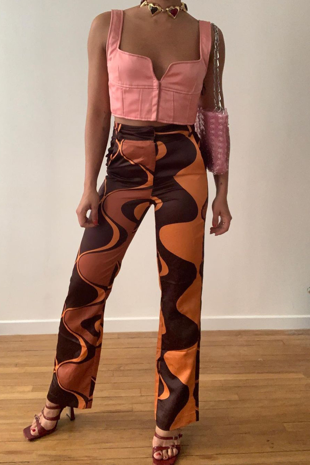 Corset Top Outfits: @maria_bernad wears a pink corset top with wave-print trousers