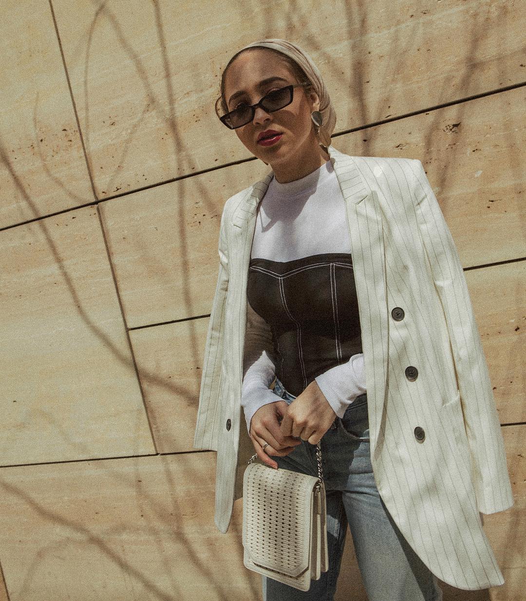 Corset Top Outfits: @mariaalia wears a corset top with a white roll neck and a cream blazer