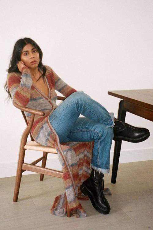 @monikh wears a long multicolour cardigan with jeans and chunky boots