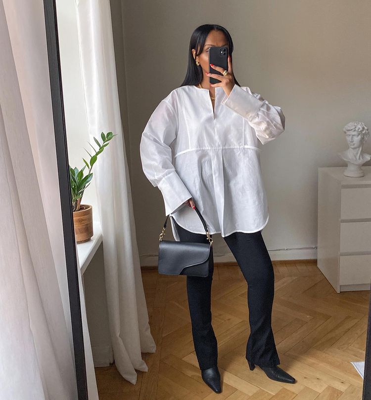 Tops to Wear With Leggings: @femmeblk wears a relaxed white shirt and black flared leggings