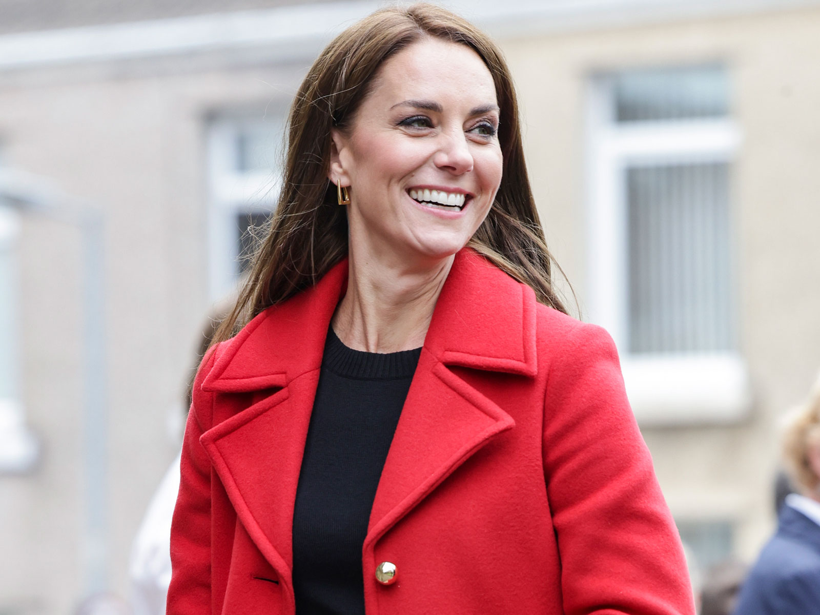 princess kate middleton wearing a red coat in wales with trousers