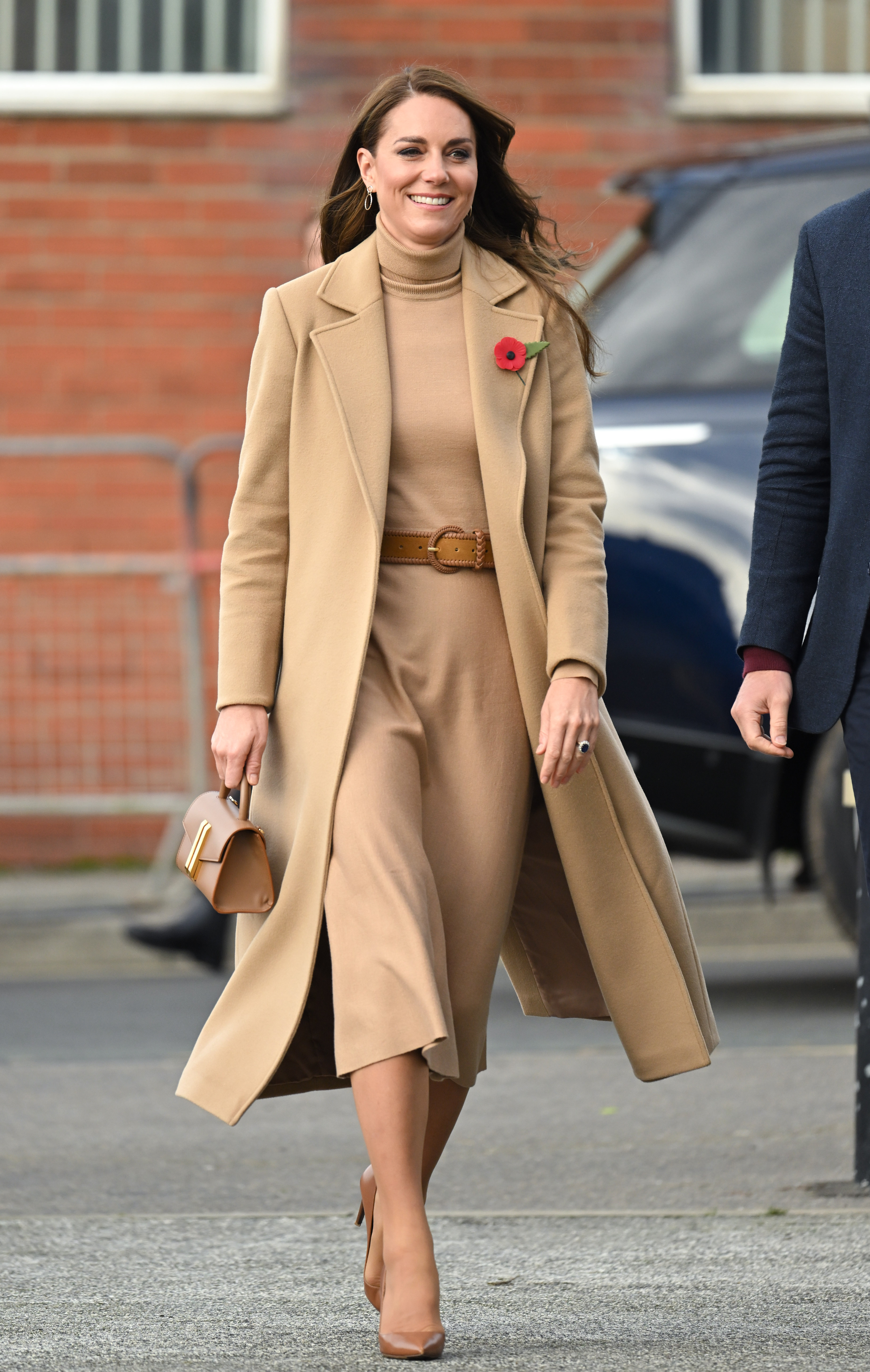 Catherine, Princess of Wales, wears a camel coat with a matching knitted dress, bag, and shoes