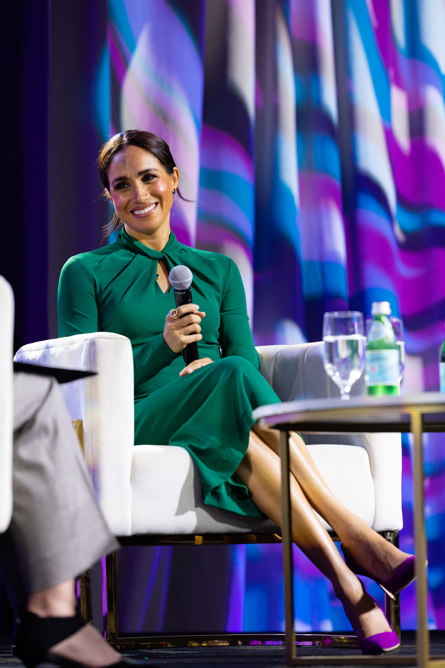 meghan markle wearing a green dress and purple shoes in indiana