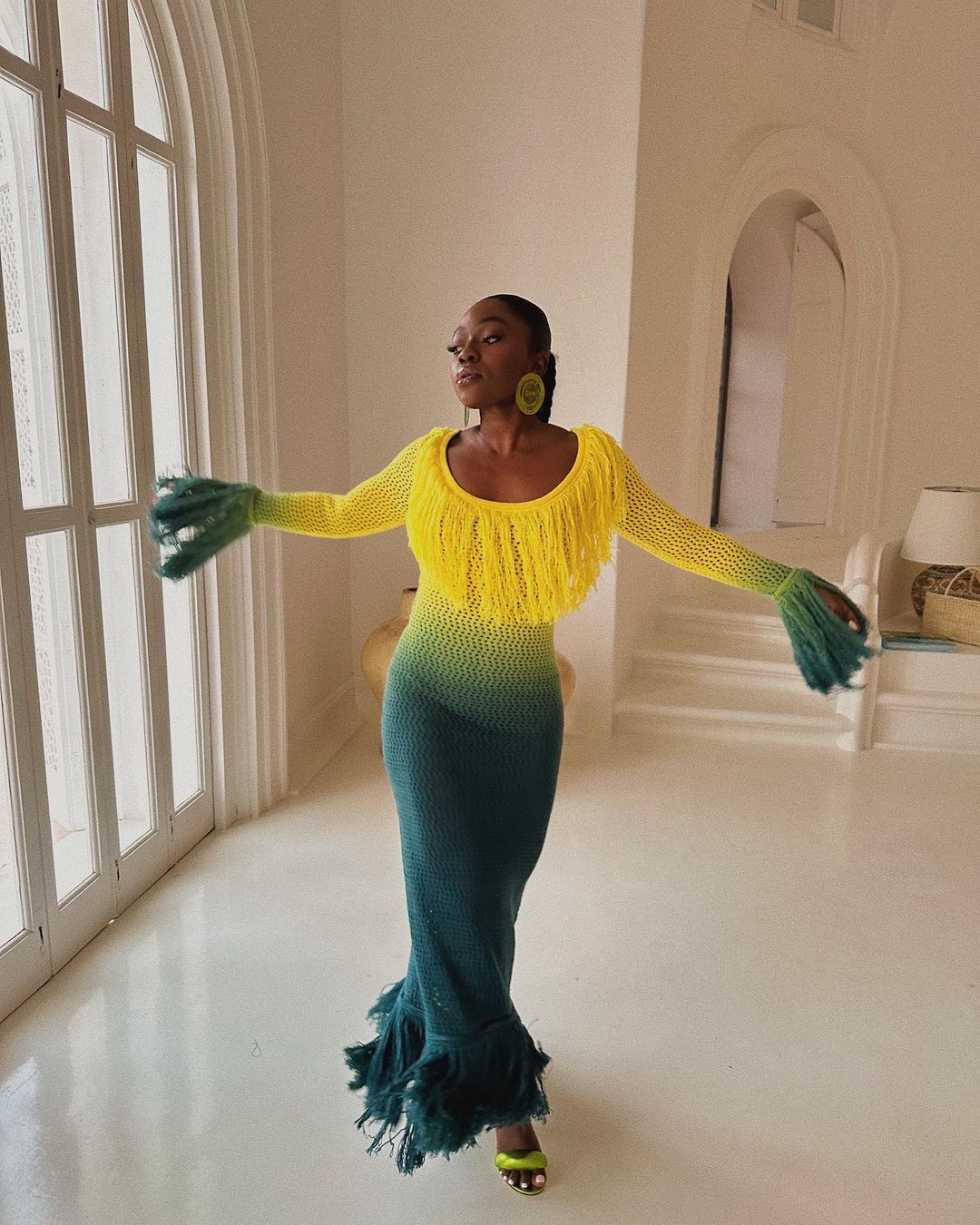 Best Dresses 2023: @fisayolonge wears a yellow to green tie-dye dress with fringed cuffs and hem