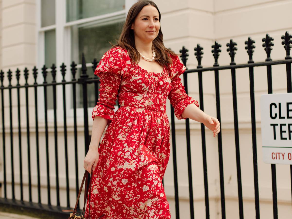 Editor Emily Dawes wears red Doen dress in street style shoot.