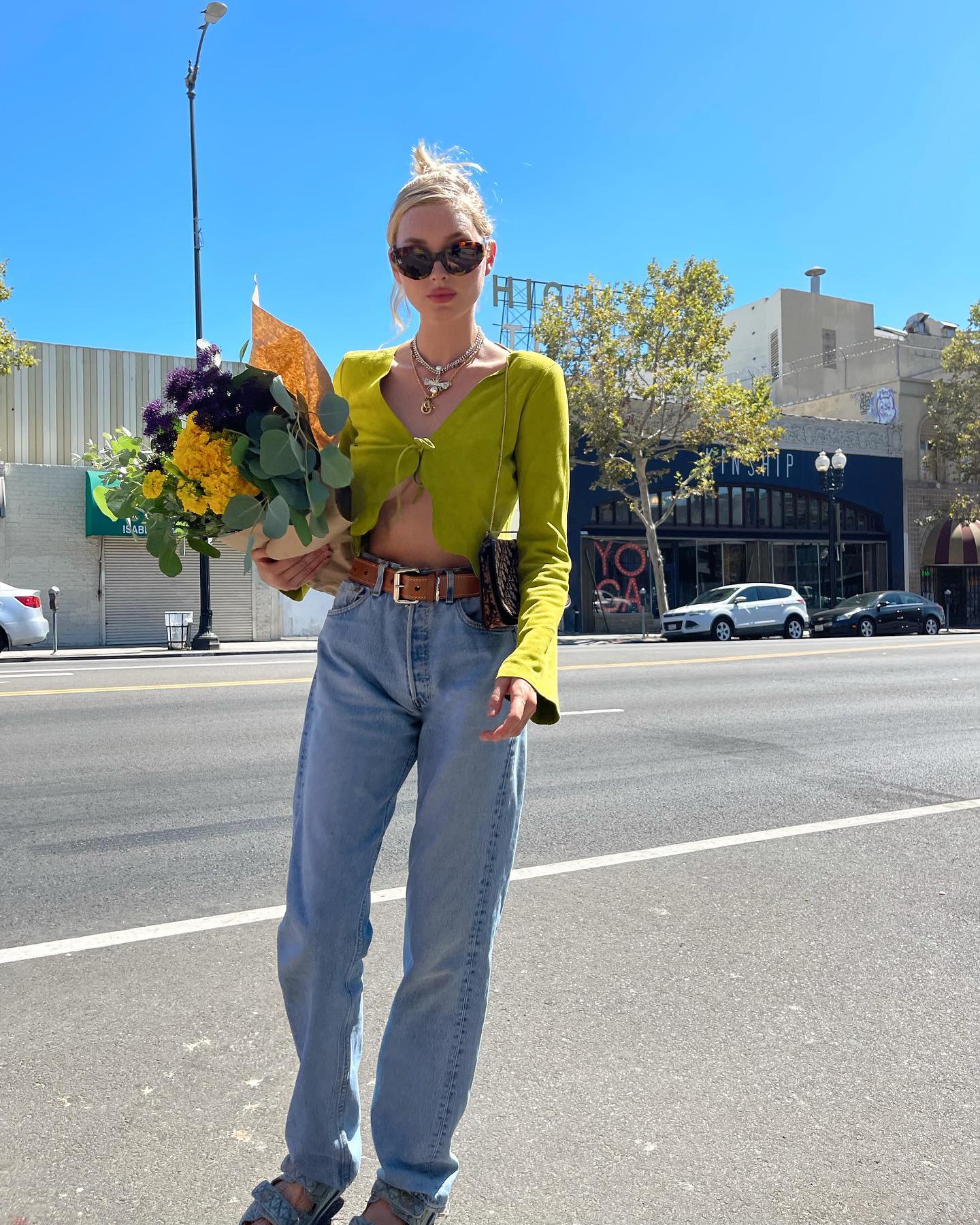 Elsa Hosk 11 Stylish Ways to Wear Tie-Front Tops for Fall Green Long Sleeve Top Baggy Jeans Belt