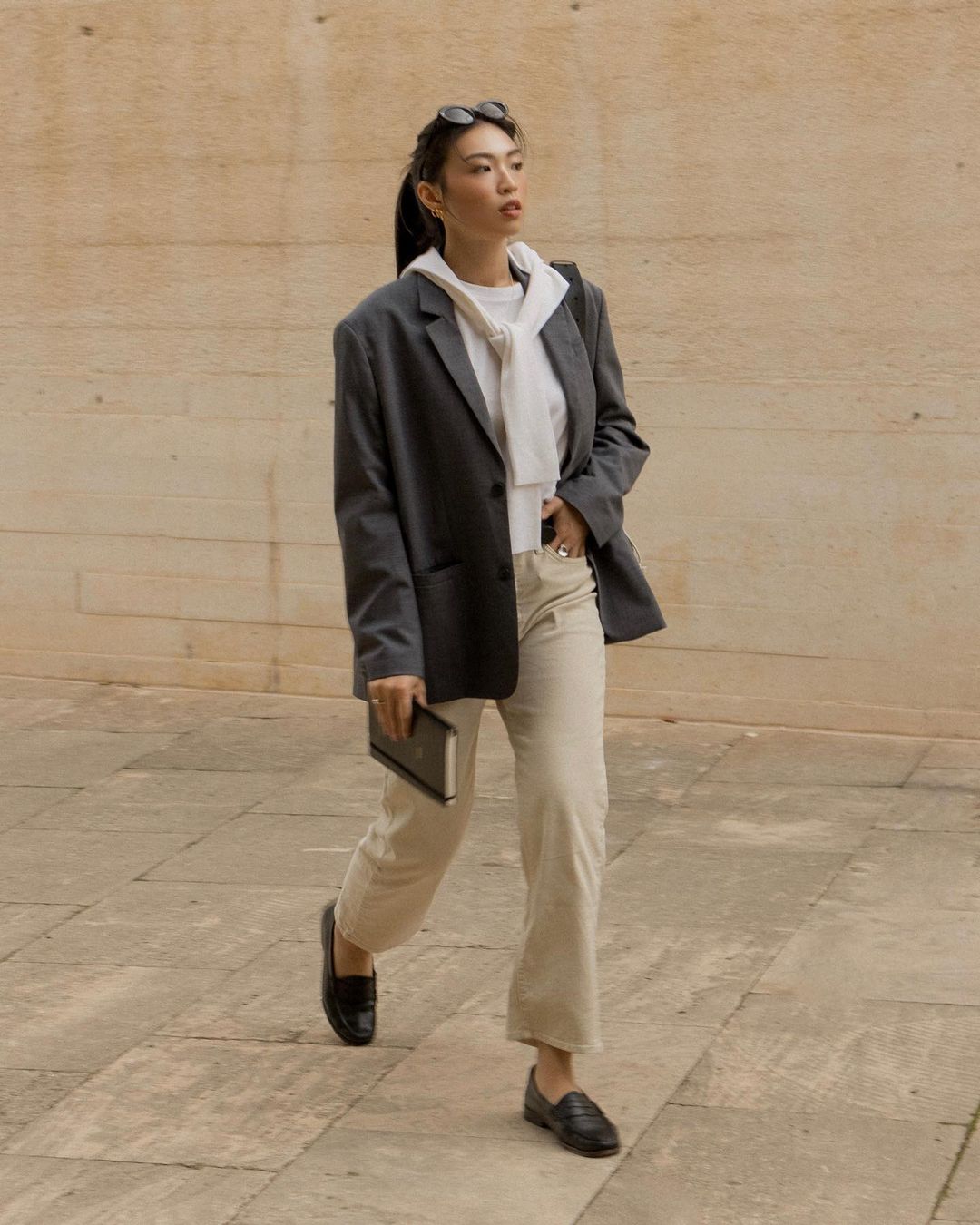 Shoes for Work: @michellelin.lin wears a pair of minimal black loafers with beige trousers