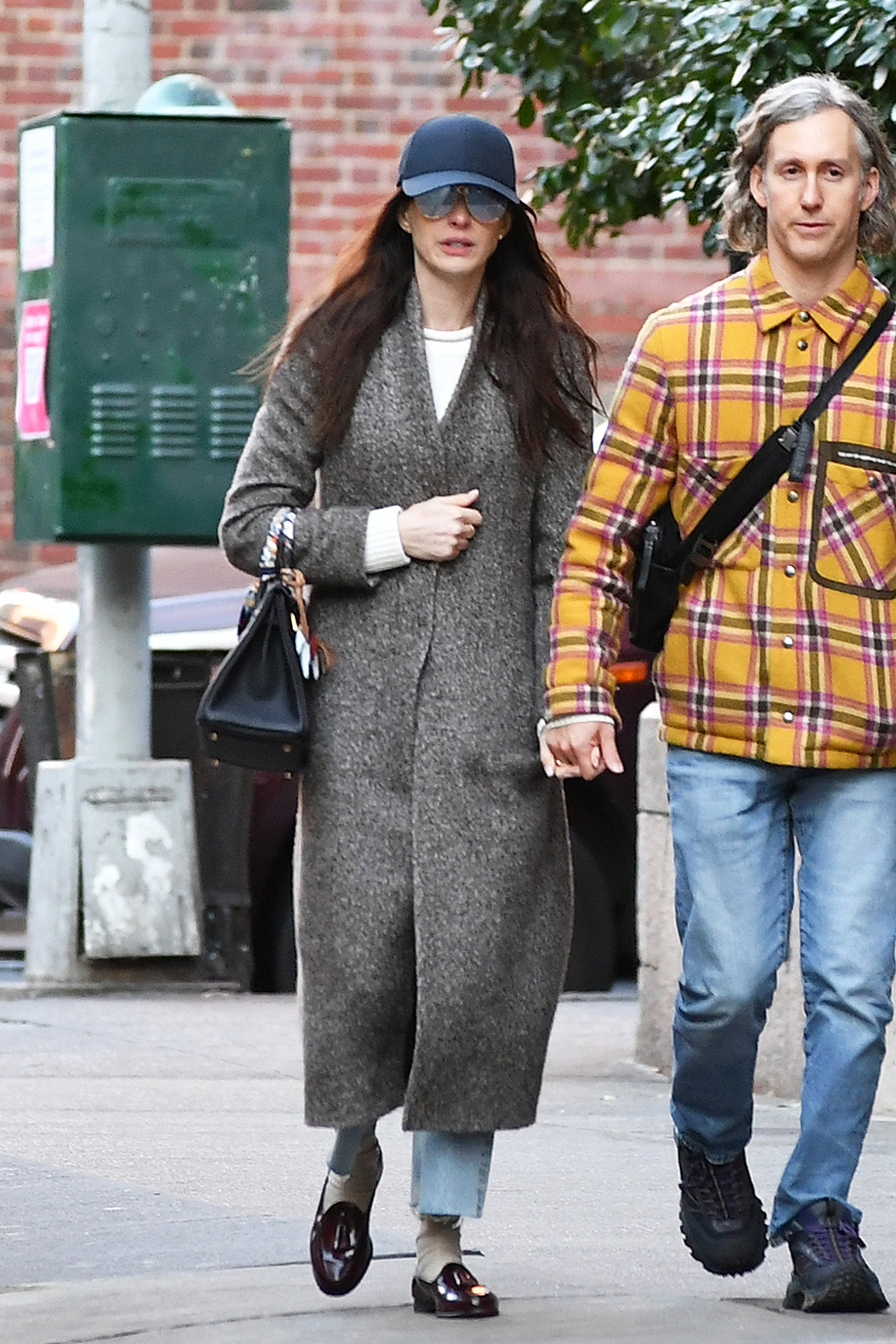 Anne Hathaway wearing a coat and cropped jeans