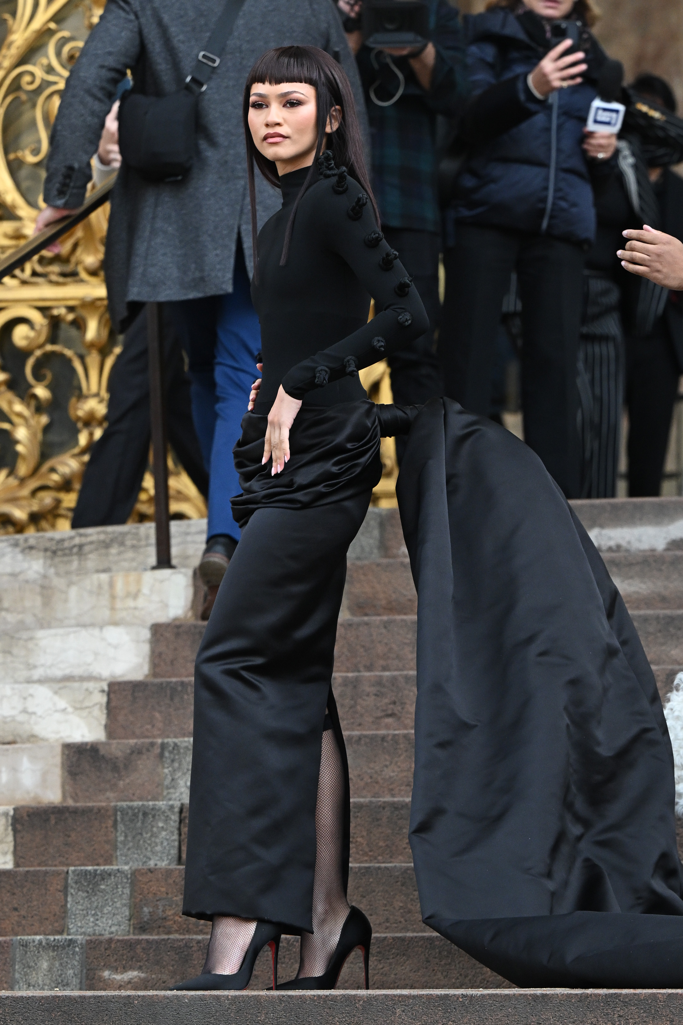 Zendaya wearing a black Schiaparelli look with a maxi-length duchesse satin skirt and train.