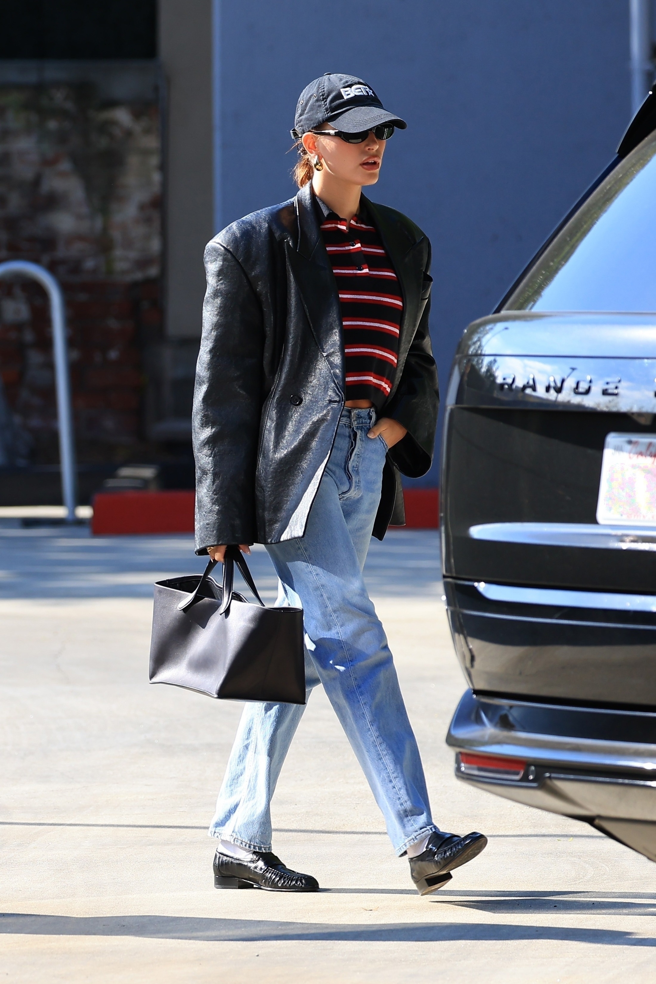 Hailey Bieber Wears a Striped Polo, Jeans, and Flats