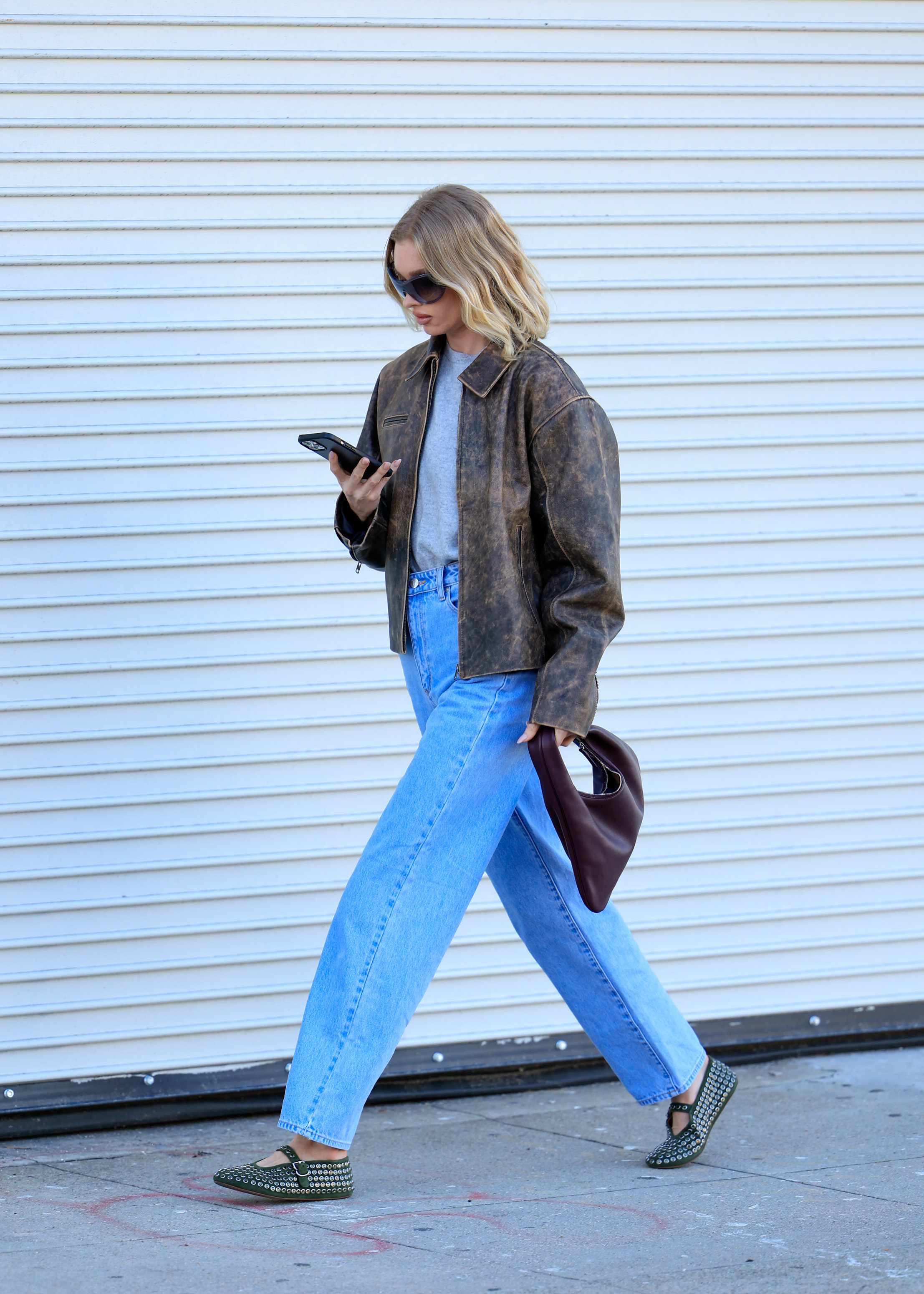 elsa hosk wearing jeans and flats with a vintage brown jacket